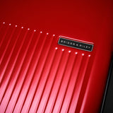 Briggs & Riley Sympatico Essential carry-on spinner luggage in glossy ruby with logo detail and sleek design.