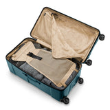 Briggs & Riley Torq extra large checked luggage trunk with interior compartments and sturdy spinner wheels.