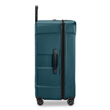 Briggs & Riley Torq extra large checked luggage trunk with spinner wheels, side view showing durable hard-shell design.