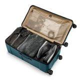 Briggs & Riley Torq extra large checked luggage trunk with interior compartments and sturdy spinner wheels.