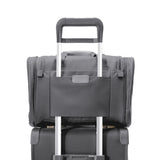 Briggs & Riley Baseline underseat duffle bag in limited edition steel gray, with handles and zippered compartments visible.