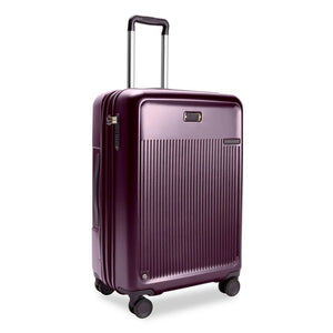 Briggs & Riley Sympatico medium expandable plum hardside spinner luggage with four wheels and a sleek design.