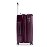 Briggs & Riley Sympatico medium expandable hardside spinner luggage in plum color with four wheels and sturdy handle.