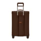 Briggs & Riley Baseline Medium Expandable Spinner luggage in limited edition chocolate color, showing the back view with wheels and handle