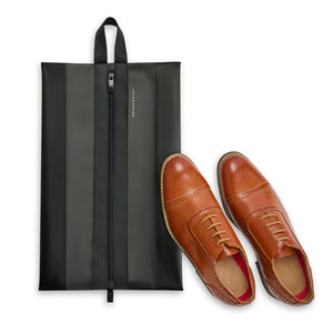 Translucent shoe pouch by Briggs & Riley for packing organization, showing clear plastic material and compact design.