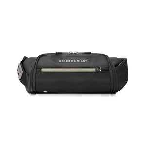 Briggs & Riley HTA sling bag in black with adjustable strap and multiple compartments, designed for comfortable everyday carry.