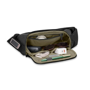 Briggs & Riley HTA sling bag showing a sleek black design with adjustable strap and compact size for everyday use.