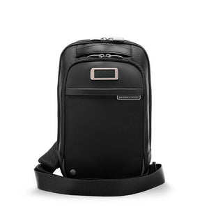 Briggs & Riley @work sling bag front view showing sleek black design with adjustable strap and compact, functional style.