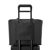 Briggs & Riley Baseline Traveler Tote bag in black with sturdy handles and multiple compartments for travel organization.