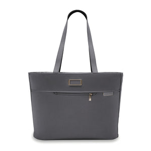 Briggs & Riley Baseline Traveler Tote in steel gray, showing a sleek, spacious nylon carryall with handles and multiple compartments.