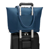 Briggs & Riley Rhapsody expandable tote bag with shoulder straps and interior compartments, shown with pass-through sleeve for travel.