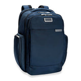Briggs & Riley Baseline Traveler Backpack shown from an angled side view with padded shoulder straps and multiple compartments.