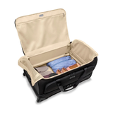 Briggs & Riley Baseline large two-wheel duffle bag with durable fabric and retractable handle, suitable for travel or weekend trips.