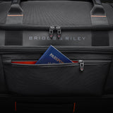 Briggs & Riley ZDX medium upright wheeled duffel with sturdy handle and wheels, black fabric with zipper compartments.
