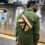 Chrome tensile sling bag in amber color with adjustable strap and sleek design, perfect for everyday carry and urban style.