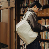 Peak Design City Backpack 15L in moon color, showing its stylish exterior and ergonomic straps for daily urban use.