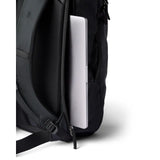 Cotopaxi Allpa 28L travel backpack in black, featuring multiple compartments and adjustable straps for versatile travel use.