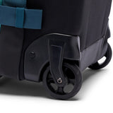 Cotopaxi Allpa 38L roller carry-on luggage in Blue Spruce with durable wheels and handle for easy travel.