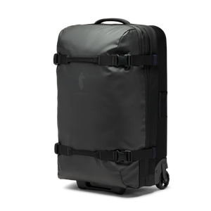 Cotopaxi 65L Roller Bag checked luggage with durable wheels and handle, black color, designed for travel and easy rolling.