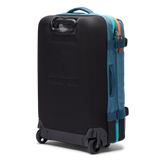 Cotopaxi 65L Roller Bag checked luggage with durable wheels and handle, designed for travel and easy maneuvering.