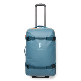 Cotopaxi 65L roller checked luggage with durable black exterior and sturdy wheels, ready for travel.