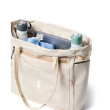 Cotopaxi Mente 22L tote bag in cream color with durable fabric and top handles, perfect for everyday use.