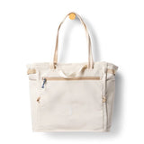 Cotopaxi Mente 22L tote bag in cream color with adjustable straps and spacious main compartment, made from durable materials.