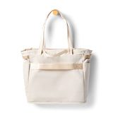 Cotopaxi Mente 22L tote bag in cream with sturdy handles and spacious interior, ideal for everyday use.