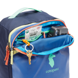 Cotopaxi Allpa Mini 20L travel pack with adjustable straps and multiple compartments, shown in vibrant colors.