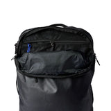 Cotopaxi Allpa 35L travel backpack in black, featuring multiple compartments and padded shoulder straps for comfortable travel.