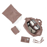 Dagne Dover Indi neoprene diaper backpack in dune color, large size, with top-down view showing multiple compartments and sleek design.