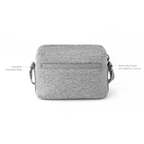 Dagne Dover Micah neoprene crossbody bag shown from the back, featuring sleek black design and adjustable strap on a neutral background.