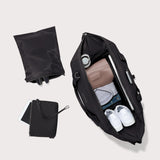 Dagne Dover Landon Neoprene Carryall Bag in Onyx, an extra-large black duffel bag with sturdy handles and spacious interior.