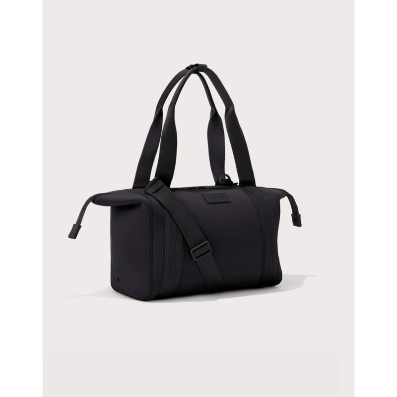 Medium Dagne Dover Landon Carryall bag with sleek design, showing its spacious interior and stylish exterior in a modern setting.