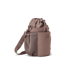 Dagne Dover Sloan water bottle sling in Dune color, featuring compact design and adjustable strap for easy carrying.
