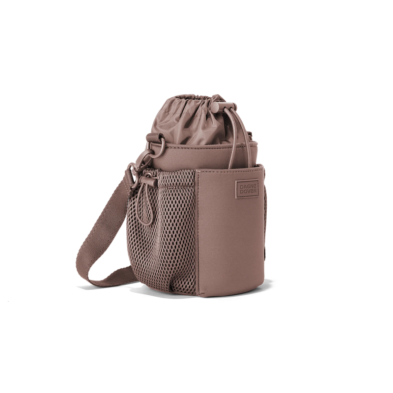 Dagne Dover Sloan water bottle sling in Dune color, featuring compact design and adjustable strap for easy carrying.