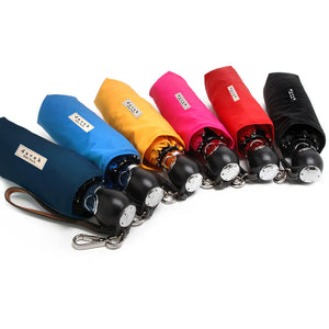 Fuschia pink Davek The Commuter Umbrella open, featuring a compact design and sturdy handle for rain protection.