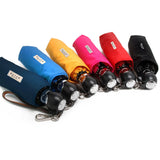 Fuschia pink Davek The Commuter Umbrella open, featuring a compact design and sturdy handle for rain protection.