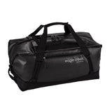 Eagle Creek Migrate Duffel 60L in black, showing the spacious fabric main compartment with handles and shoulder strap for travel.