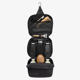 Eagle Creek Pack-It Reveal Tri-Fold Toiletry Kit in Mandarin with multiple compartments and hanging hook for travel organization.