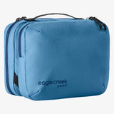 Eagle Creek Pack-It Reveal Tri-Fold Toiletry Kit in orange, with multiple compartments and zippered closure for travel organization.