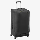 Eagle Creek Expanse 4-Wheel 30-inch travel luggage in pilot blue with a hard shell and extended handle for easy rolling.