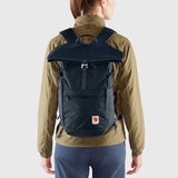 Fjallraven High Coast Foldsack 24 backpack in black with front zip pocket and adjustable shoulder straps, on a plain background.