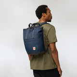 Fjallraven High Coast Totepack in black with leather accents, showing its sleek design and adjustable shoulder straps.