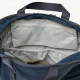 Fjallraven High Coast Totepack backpack in black fabric with adjustable straps and zipper compartments on a plain background