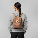 Fjallraven Kanken Mini backpack in vibrant red with top handle and adjustable shoulder straps, front zip pocket, and logo patch.