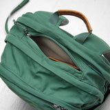 Fjallraven Raven 28 backpack in dark green with adjustable shoulder straps and front zip pocket, designed for outdoor use.