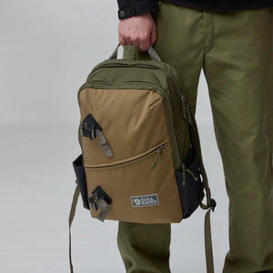 Fjallraven Vardag Backpack 17 in dark green with leather accents, showing front view with zipper compartments and adjustable straps.