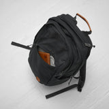 Fjallraven Raven 20 backpack in black with adjustable shoulder straps and front zip pocket, designed for outdoor and everyday use.
