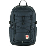 Fjallraven Skule 20 backpack in dark green with multiple compartments and padded shoulder straps, designed for outdoor use.